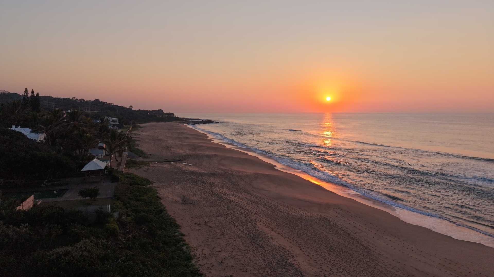 Small group walking a South African coastline at sunrise